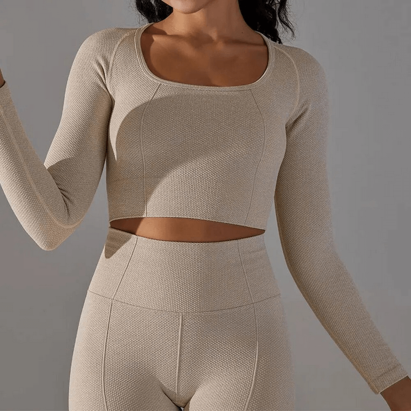 Women's seamless bodycon crop top with long sleeves, ideal for running and yoga, showcasing a comfortable nylon-spandex fabric in beige.